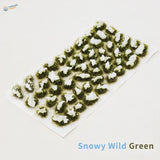 Snowy grass patches with miniature tufts and textured white snow caps