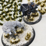 Detailed grey wolf miniature on snowy grass patches base