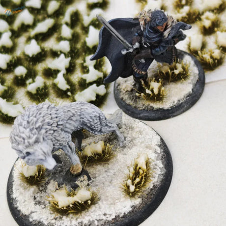 Detailed grey wolf miniature on snowy grass patches base