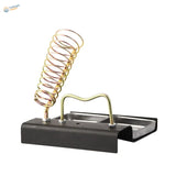 Gold soldering iron support station with black base and silver tray