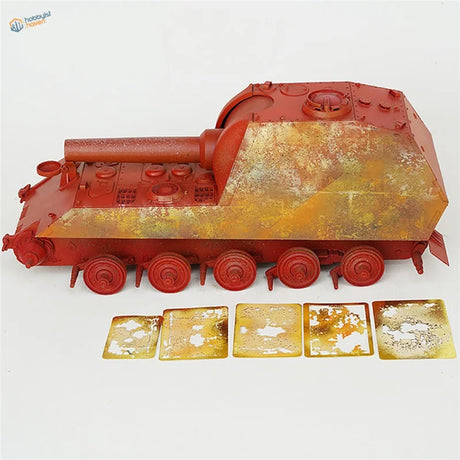 Red plastic model tank with weathering effects stencil camouflage