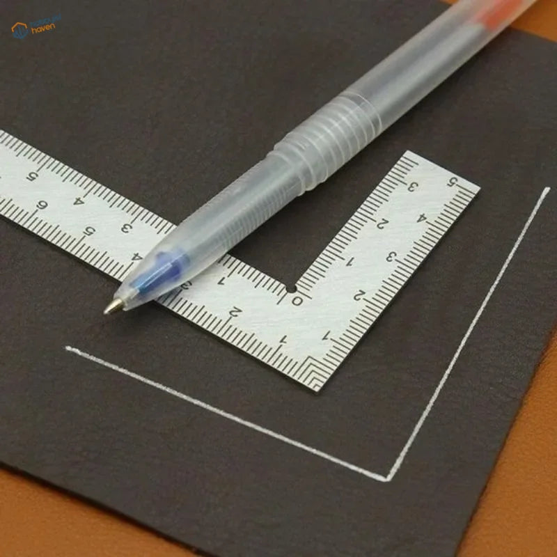 A compact stainless steel mini try square with a transparent blue ink pen resting diagonally across the ruler