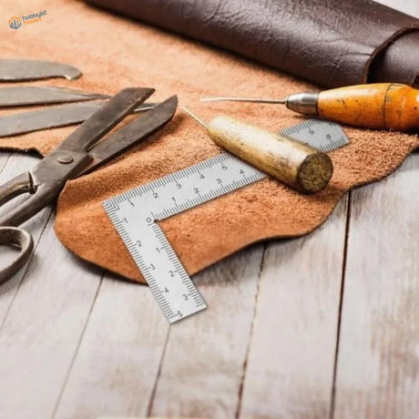 Stainless steel mini try square on brown leather work surface with tools and measuring instruments, compact stainless type