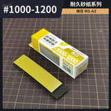 Yellow and black sponge sandpaper with a grit range of #1000-1200, packaged in a white box labeled ’sponge sandpaper’ by the brand steeldyne.