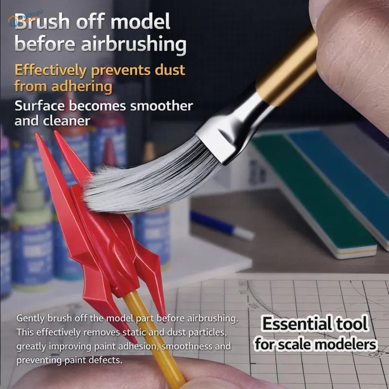 A stedi ms-86 anti-static dust brush with white bristles cleaning a red plastic model rocket for scale modeling tools