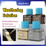 Four stedi weathering wash bottles with bright blue caps containing colored liquids for realistic scale models