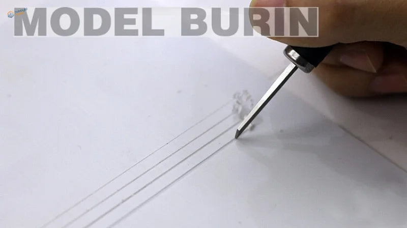 Tungsten steel burin etching fine lines into white paper