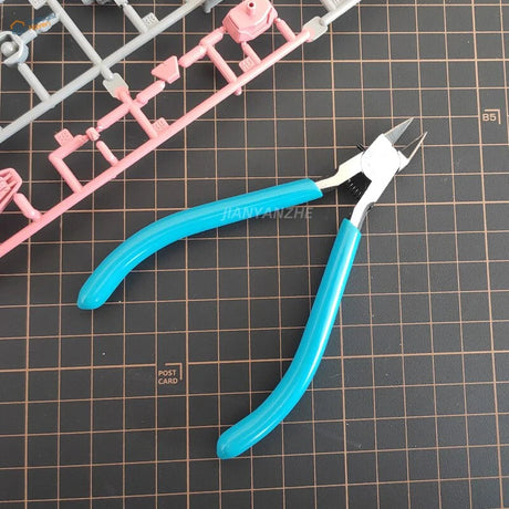 Blue-handled Ultra Thin Blade Side-Cutters on grid mat for scale modeling