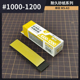 Yellow and black sponge sandpaper with a grit range of #1000-1200, packaged in a white box labeled ’sponge sandpaper’ by the brand steeldyne.