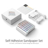 White plastic storage case holding seven self-adhesive sandpaper strips with different grits for gee hobby sanding sticks