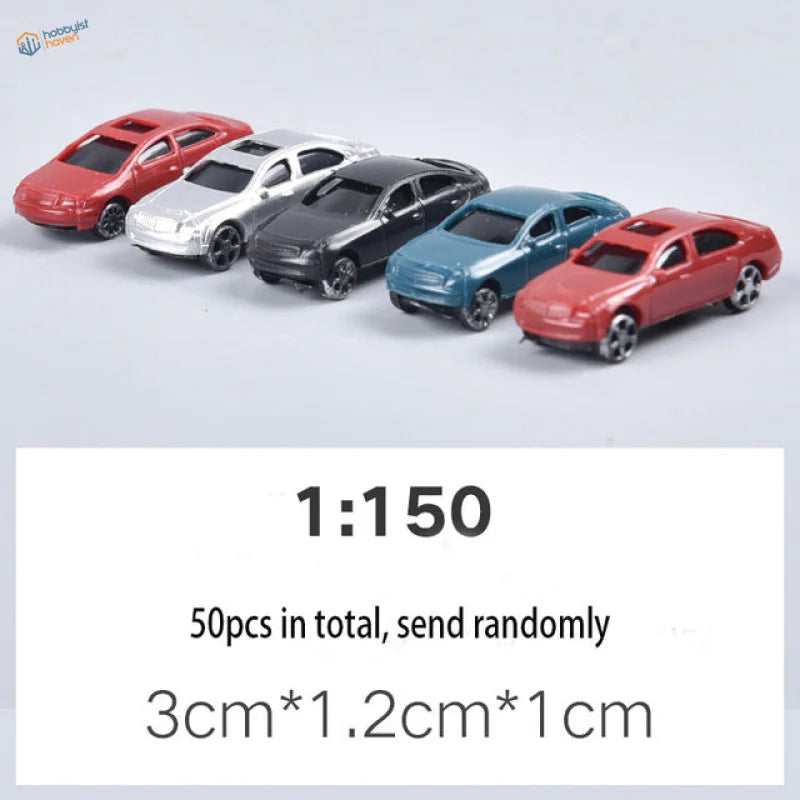 Five glossy toy cars in red, silver, black, blue, red for scale railway modeling
