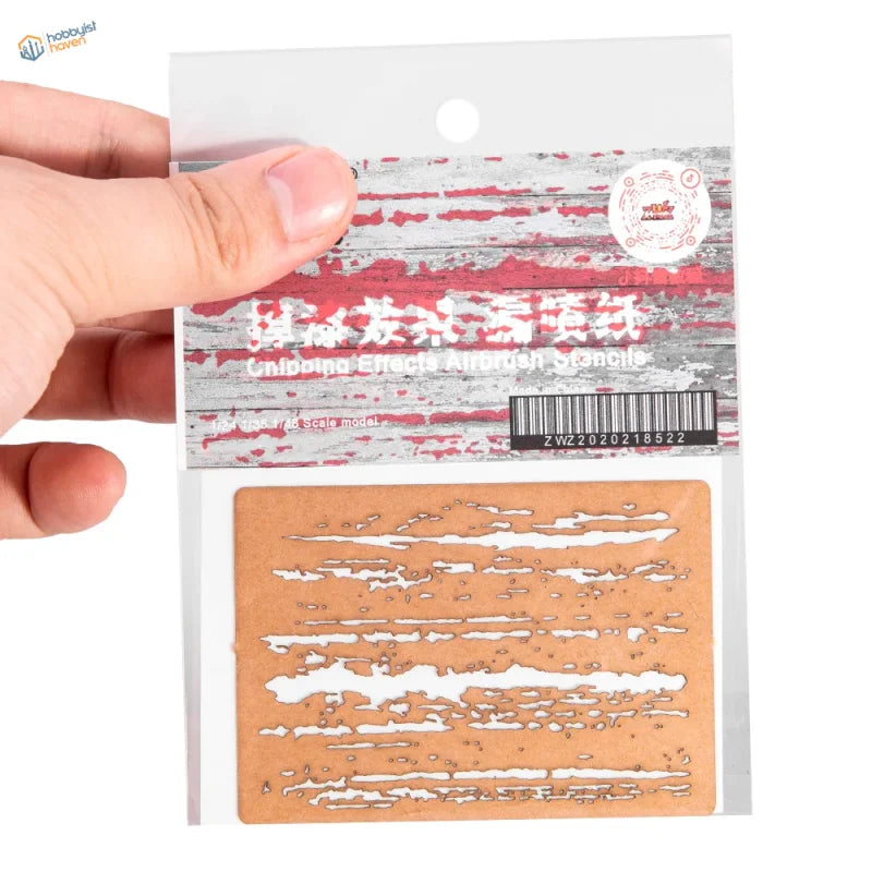 Brown cardboard weathering effects stencil with white brushstrokes for scale modeling